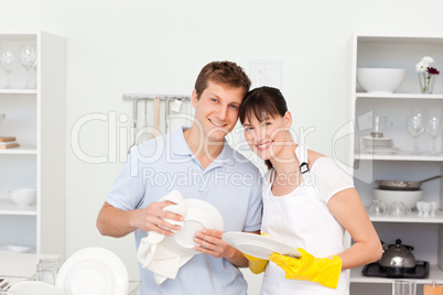 Couple washing dishes together