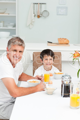 Father having his breakfast with his son