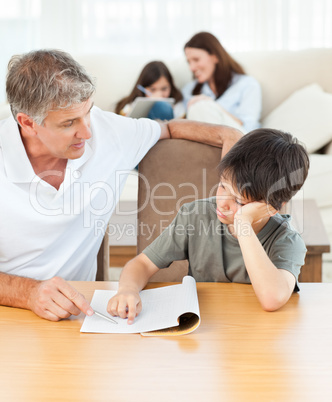 Father helping his son with his homework