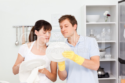 Lovers washing dishes together