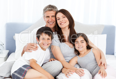 Family  lying down on their bed