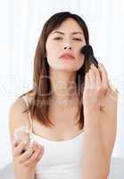 Lovely woman making up