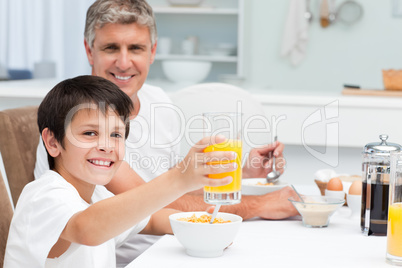 Father having his breakfast with his son