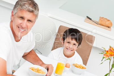 Father having his breakfast with his son