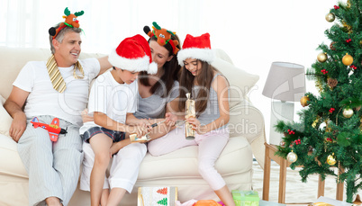 Family during Christmas day looking at their presents