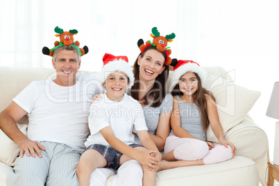 Family during Christmas day looking at the camera