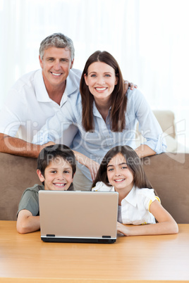 Joyful family looking at the camera