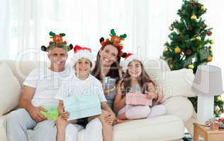 Family during Christmas day looking at the camera