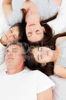 Family  lying down on their bed