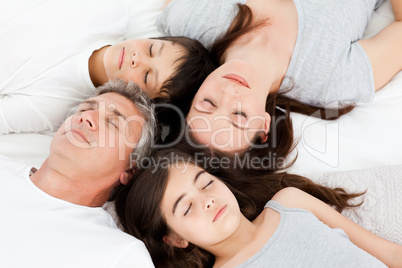 Family  lying down on their bed
