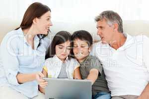 Family looking at  the laptop
