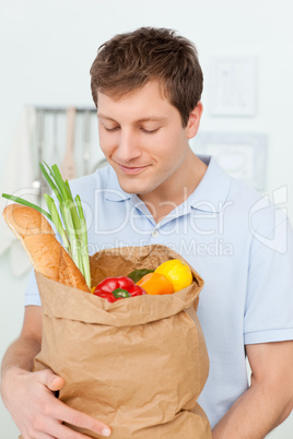 Man with shoping bags in the kitchen