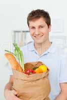 Man with shoping bags in the kitchen