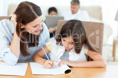 Mother helping her daughter for her homework