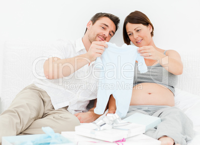 Young futur parents with chlidrens clothes