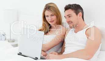 Lovers watching a movie on their laptop