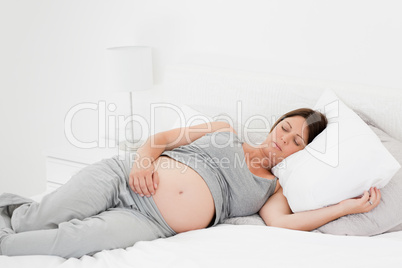 Pregnant woman on her bed
