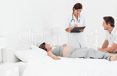 Pregnant woman with her husband and a nurse