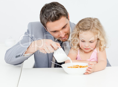 Father having breakfast with her daughter