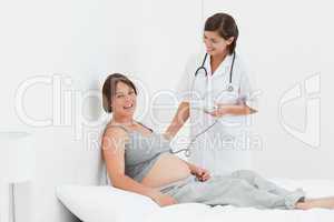 Pregnant woman with a nurse smilling