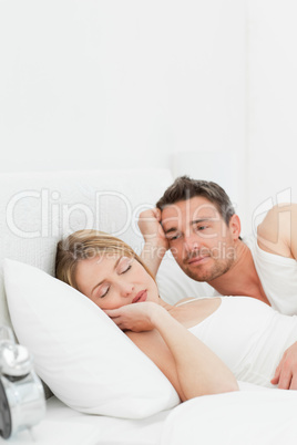 Boyfriend looking at his girlfriend who is  sleeping