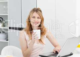 Woman drinking coffee in her kitchen