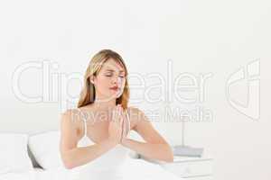 Woman practice yoga on her bed