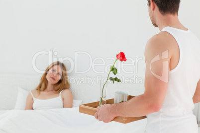 Joyful lovers having breakfast in their bed