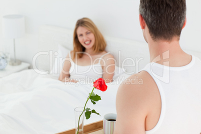 Joyful lovers having breakfast in their bed