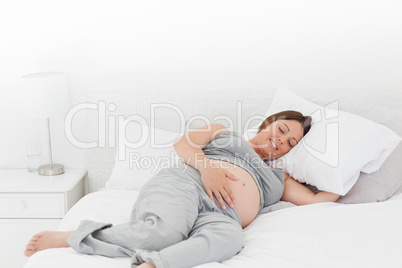 Pregnant woman on her bed