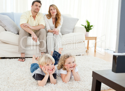 Adorable family watching tv