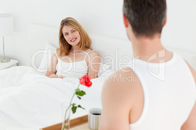 Joyful lovers having breakfast in their bed