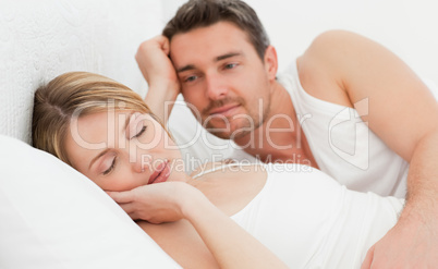 Boyfriend looking at his girlfriend who is  sleeping