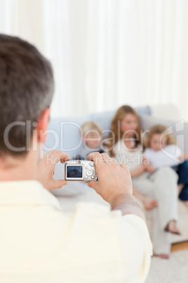 Man taking a photo of his family