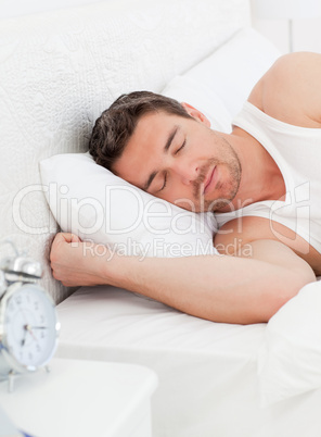 A peaceful man in his bed before waking up