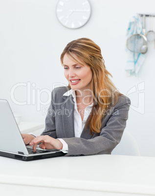 Businesswoman looking at her laptop