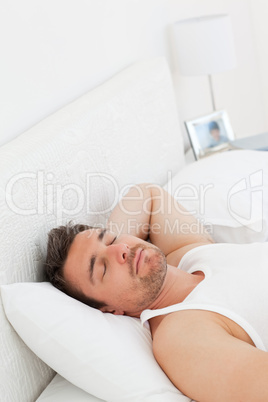 A relaxed man in his bed before waking up