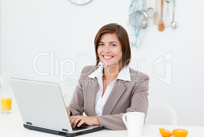 Smiling businesswoman working on her laptop