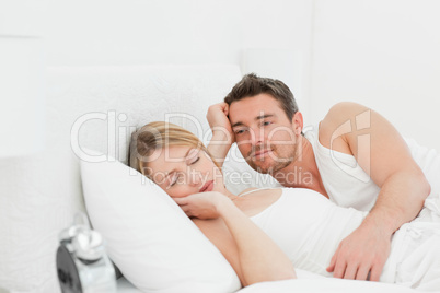 Boyfriend looking at his girlfriend who is  sleeping