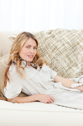 Wonderful woman lying down on her sofa