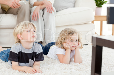 Adorable family watching tv