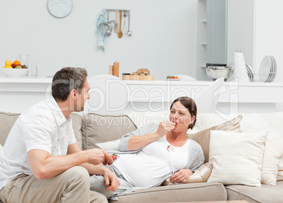 Pregnant woman with her husband eating strawberry