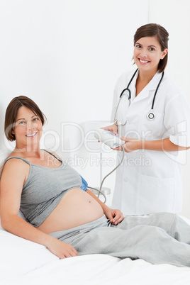 Pregnant woman with a nurse smilling