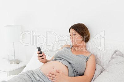 Pregnant woman looking at her mobile
