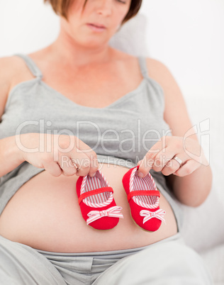 Pregnant woman with kids shoes