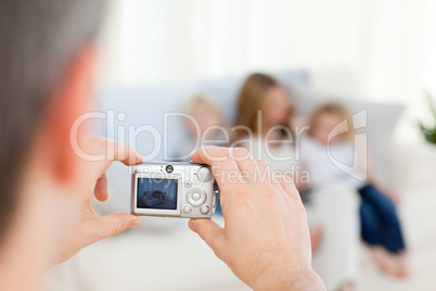 Man taking a photo of his family