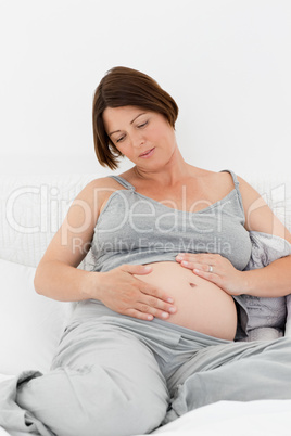 Pregnant woman cuddling her belly