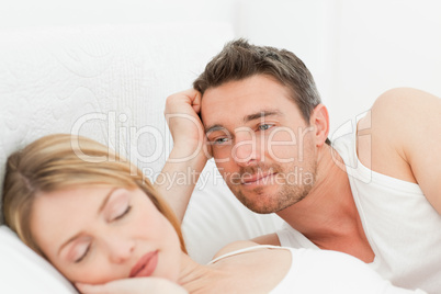 Boyfriend looking at his girlfriend who is  sleeping