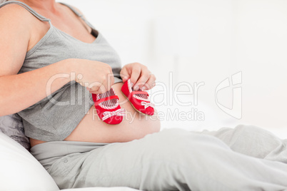 Pregnant woman with kids shoes