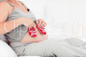 Pregnant woman with kids shoes